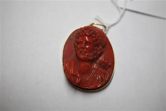 An antique Italian gold mounted oval coral cameo pendant, carved with the bust of a bearded archer, 41mm.